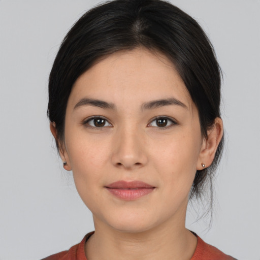 Joyful white young-adult female with medium  black hair and brown eyes