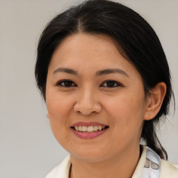 Joyful asian young-adult female with medium  brown hair and brown eyes