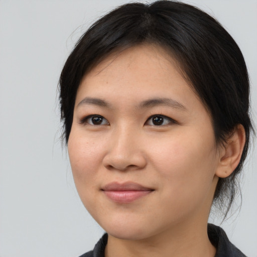 Joyful asian young-adult female with medium  brown hair and brown eyes