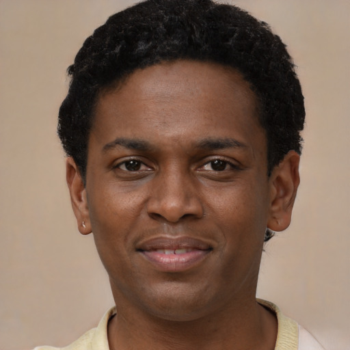 Joyful latino young-adult male with short  brown hair and brown eyes