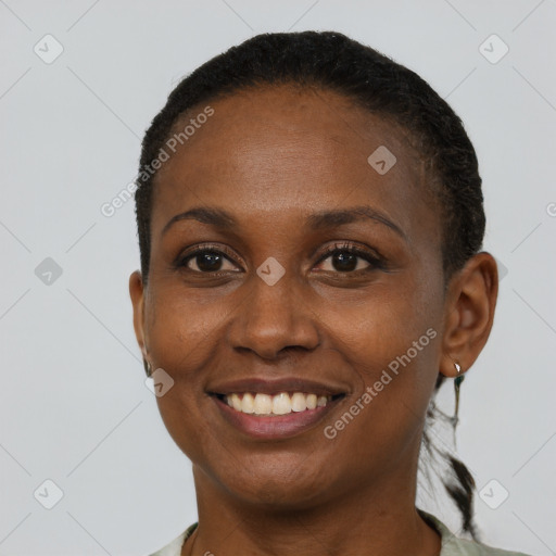 Joyful black young-adult female with short  brown hair and brown eyes