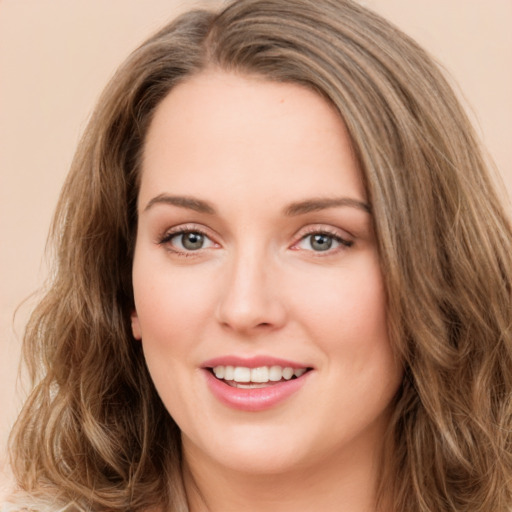 Joyful white young-adult female with long  brown hair and green eyes