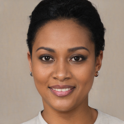 Joyful black young-adult female with short  brown hair and brown eyes