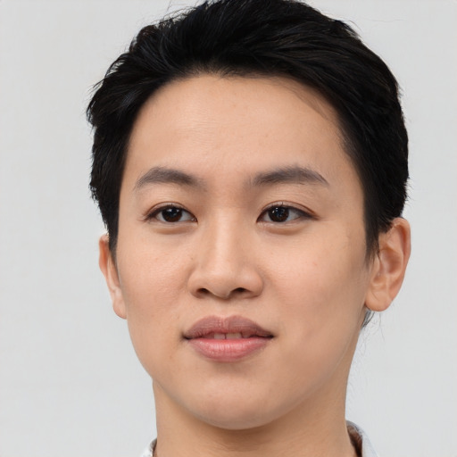 Joyful asian young-adult female with short  black hair and brown eyes