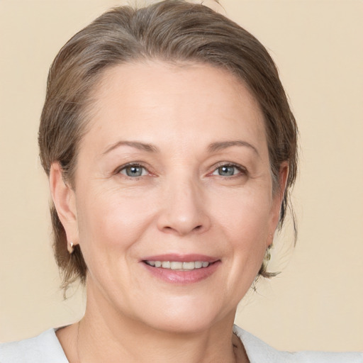 Joyful white adult female with medium  brown hair and brown eyes