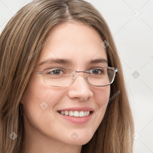 Joyful white young-adult female with long  brown hair and green eyes