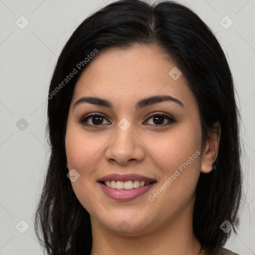 Joyful latino young-adult female with long  brown hair and brown eyes