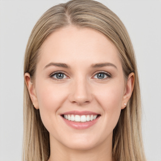 Joyful white young-adult female with long  brown hair and blue eyes