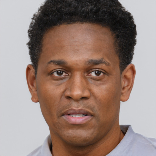 Neutral black adult male with short  black hair and brown eyes