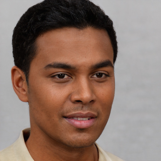 Joyful latino young-adult male with short  brown hair and brown eyes