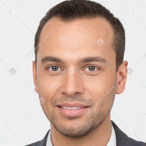 Joyful white young-adult male with short  brown hair and brown eyes