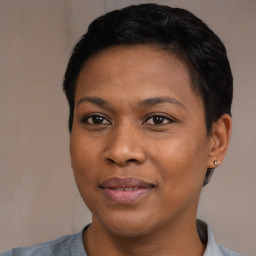 Joyful black adult female with short  black hair and brown eyes