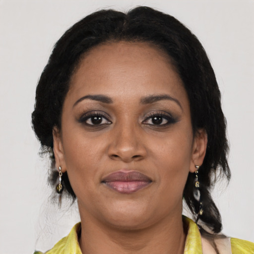 Joyful black adult female with medium  brown hair and brown eyes