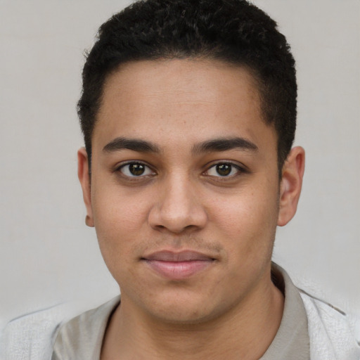 Joyful white young-adult male with short  black hair and brown eyes