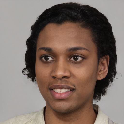Joyful black young-adult female with short  black hair and brown eyes