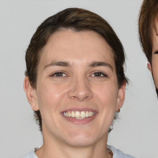 Joyful white young-adult female with medium  brown hair and brown eyes