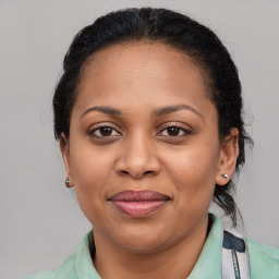 Joyful black adult female with medium  brown hair and brown eyes