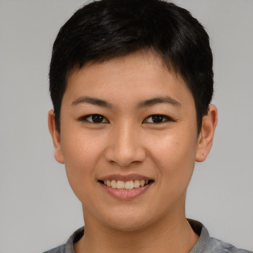 Joyful asian young-adult female with short  brown hair and brown eyes