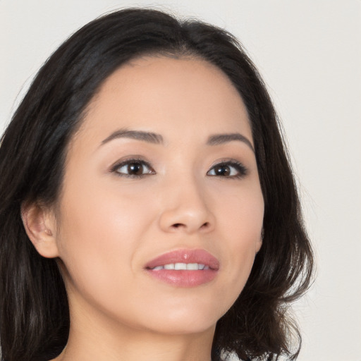 Joyful asian young-adult female with long  brown hair and brown eyes