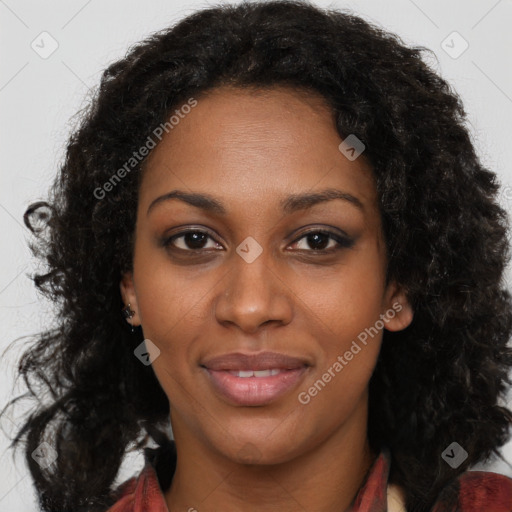 Joyful black young-adult female with long  brown hair and brown eyes
