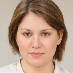 Joyful white adult female with medium  brown hair and grey eyes