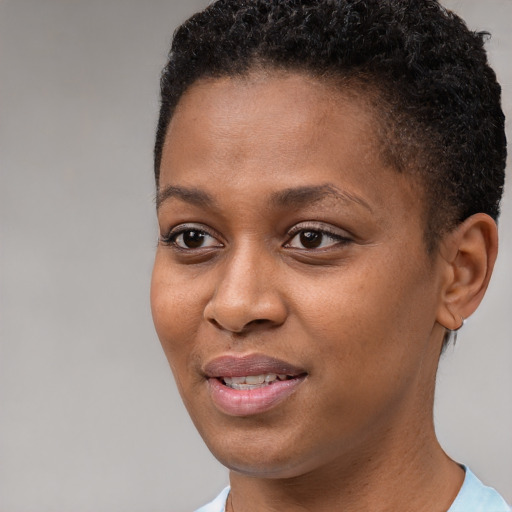 Joyful black young-adult female with short  brown hair and brown eyes