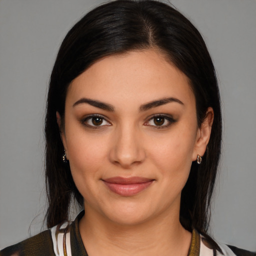 Joyful latino young-adult female with medium  brown hair and brown eyes