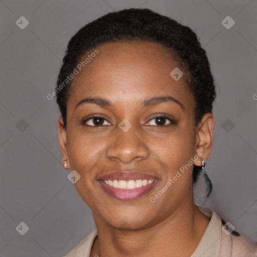 Joyful black young-adult female with short  black hair and brown eyes