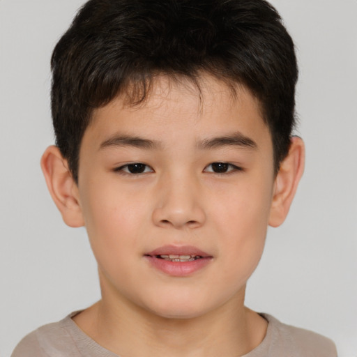 Joyful asian child male with short  brown hair and brown eyes