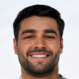 Joyful white young-adult male with short  black hair and brown eyes