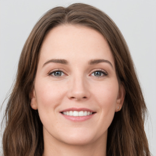 Joyful white young-adult female with long  brown hair and grey eyes