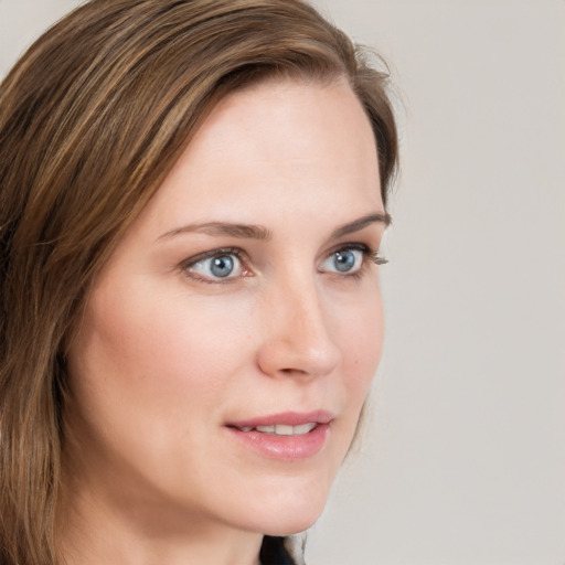 Joyful white young-adult female with long  brown hair and blue eyes