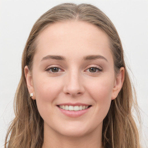 Joyful white young-adult female with long  brown hair and grey eyes