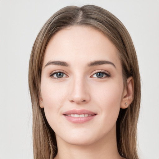 Joyful white young-adult female with long  brown hair and grey eyes