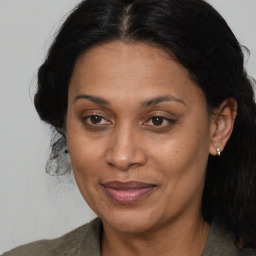 Joyful black adult female with medium  brown hair and brown eyes