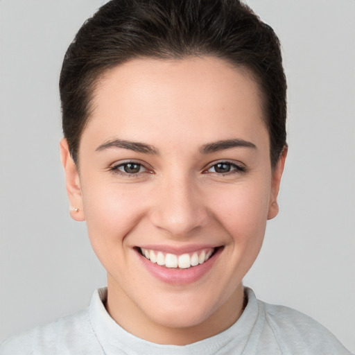 Joyful white young-adult female with short  brown hair and brown eyes