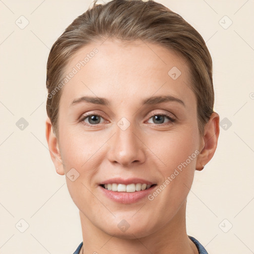 Joyful white young-adult female with short  brown hair and grey eyes