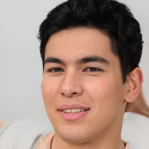 Joyful asian young-adult male with short  brown hair and brown eyes