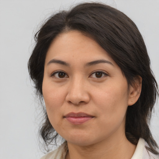 Joyful latino young-adult female with medium  brown hair and brown eyes