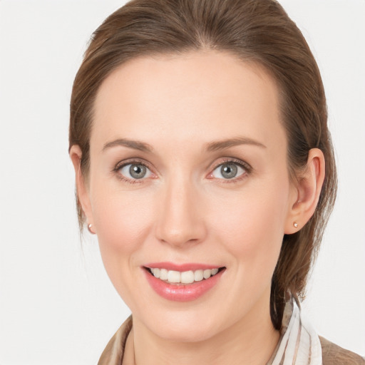 Joyful white young-adult female with long  brown hair and grey eyes