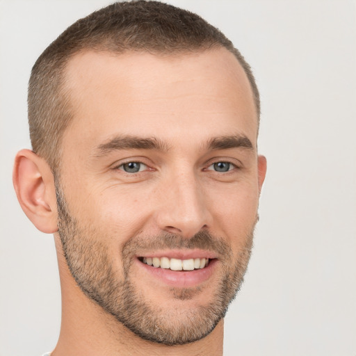 Joyful white young-adult male with short  brown hair and brown eyes