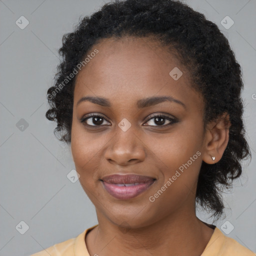 Joyful black young-adult female with long  black hair and brown eyes