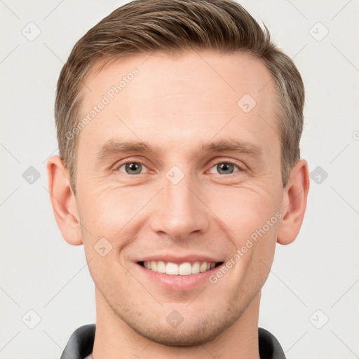 Joyful white young-adult male with short  brown hair and grey eyes