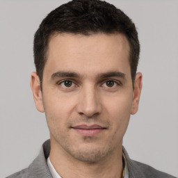 Joyful white young-adult male with short  brown hair and brown eyes