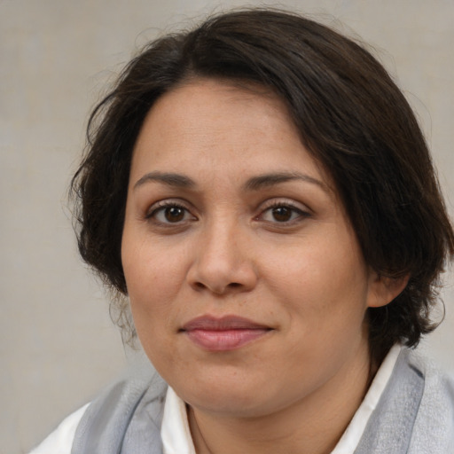 Joyful white adult female with medium  brown hair and brown eyes