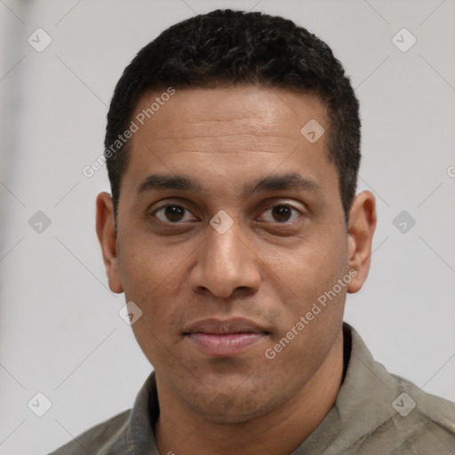 Joyful white young-adult male with short  black hair and brown eyes