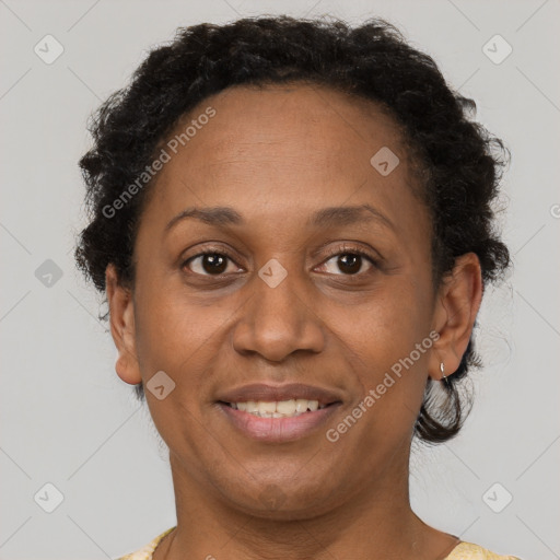 Joyful black adult female with short  brown hair and brown eyes