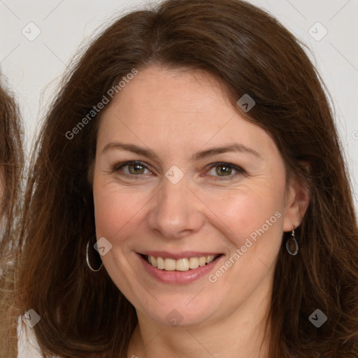 Joyful white adult female with long  brown hair and brown eyes