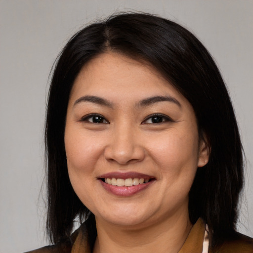 Joyful latino young-adult female with medium  black hair and brown eyes