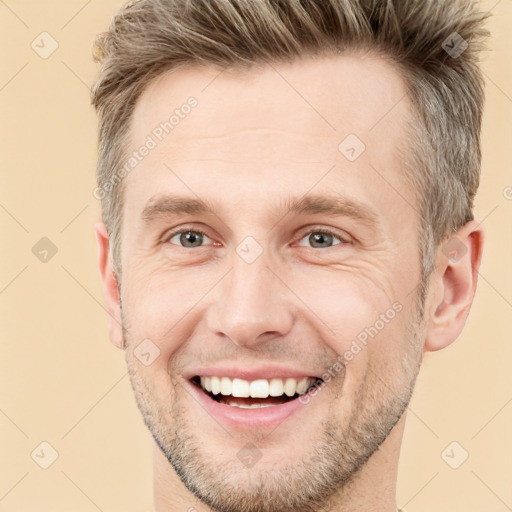 Joyful white adult male with short  brown hair and brown eyes